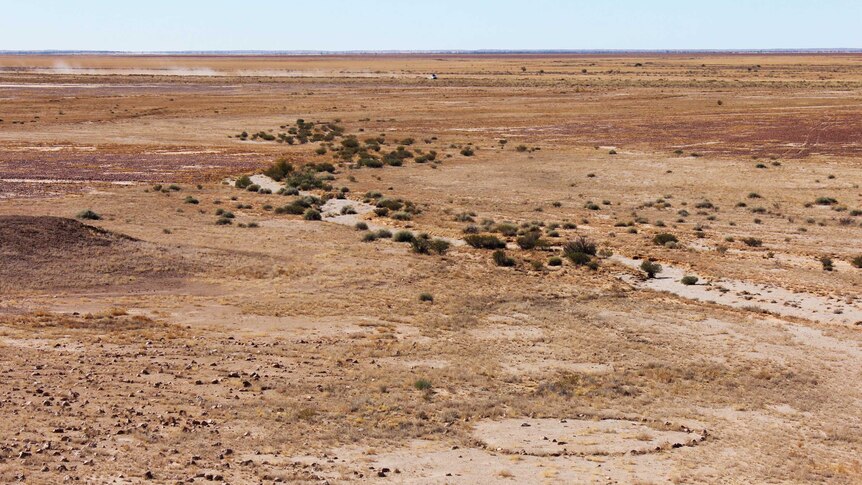 The channel country is full of red dirt, gibber rock, and stone circles - like the one pictured in this images far right.