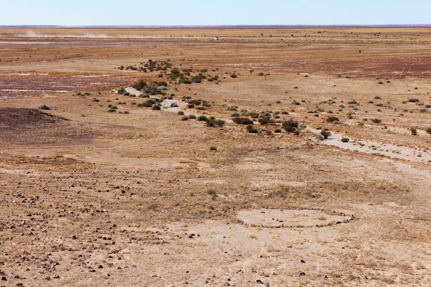 The channel country is full of red dirt, gibber rock, and stone circles - like the one pictured in this images far right.