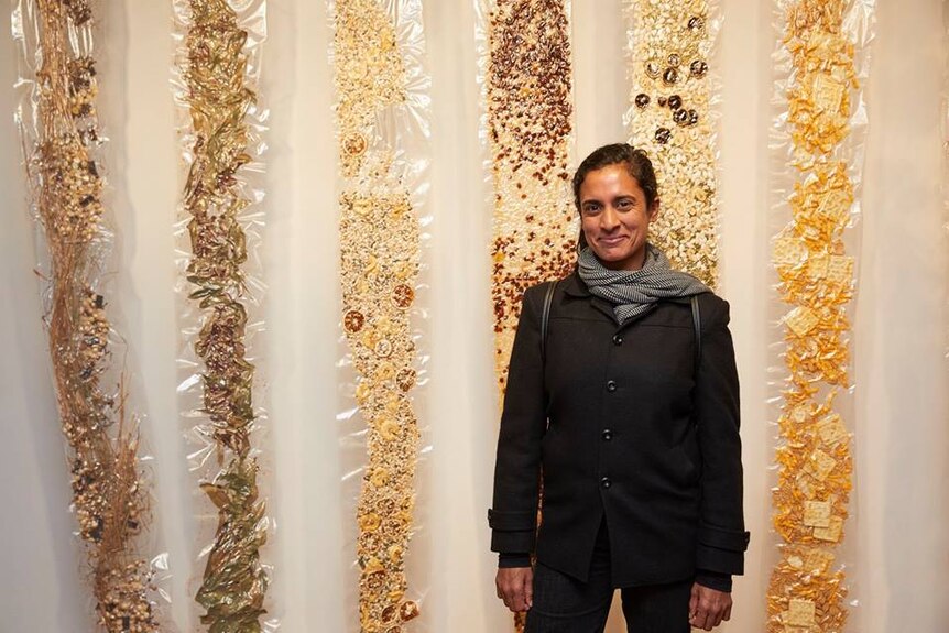 Artist Keg de Souza with her artwork in the New Sacred exhibition