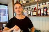 woman polishes wine glass