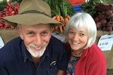 John and Joyce Walsh pose with their fresh grown produce.