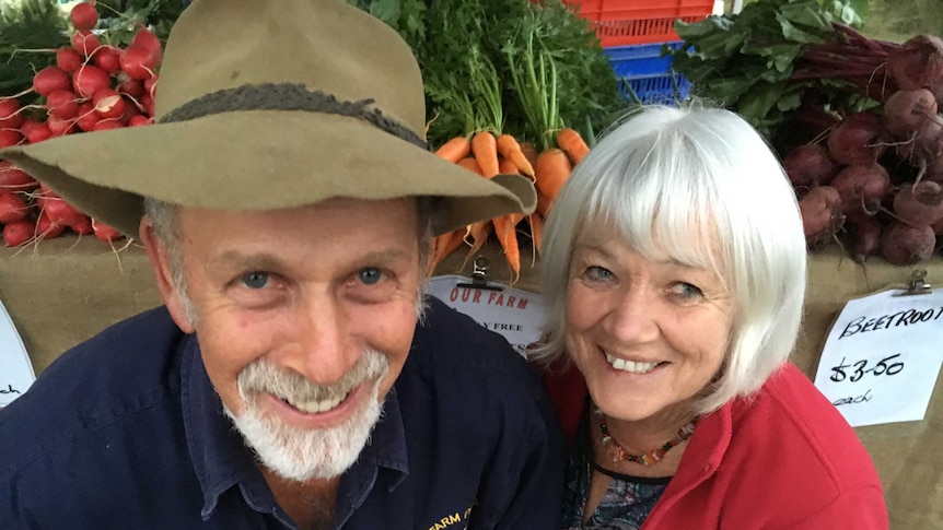 John and Joyce Walsh pose with their fresh grown produce.