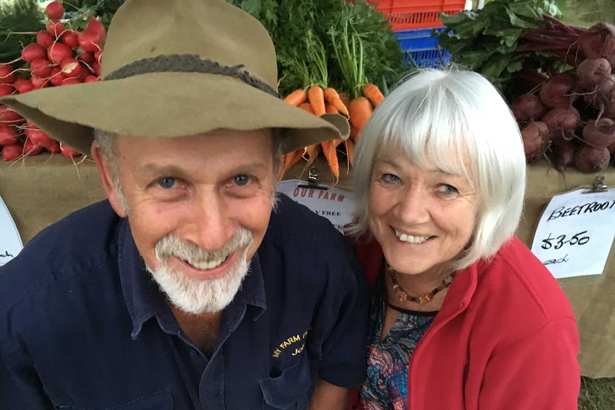 John and Joyce Walsh pose with their fresh grown produce.