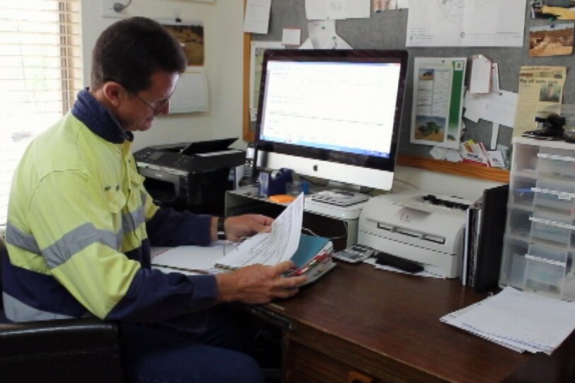 Farmer Paul Carmody sits at his computer