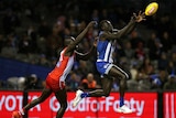 Majak Daw marks in front of Aliir Aliir during the North Melboure versus Sydney match.