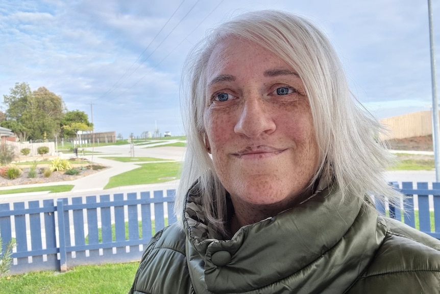 A woman with light blonde hair smiles in a selfie. 