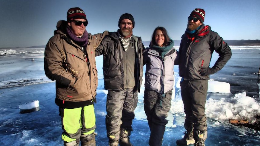 Four friends from Darwin stand on a lake in Siberia.