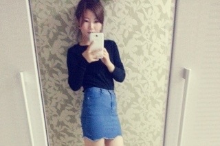 Eunhee takes a photo on her phone in front of a mirror