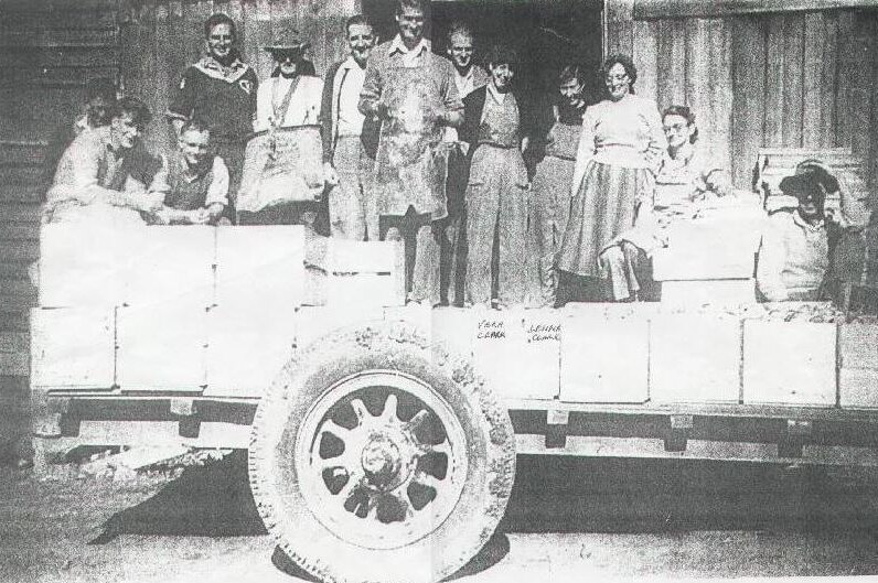 1949 photo of people in the tray of a truck.