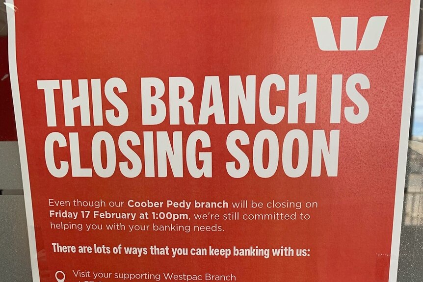 A red poster with white text saying This branch is closing soon. Fine print about details below.  Westpac logo on top right.