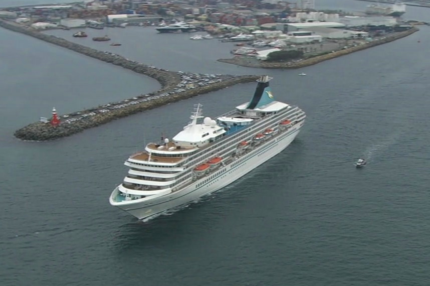 An aerial image of the Artania cruise ship sailing away from Fremantle Port.