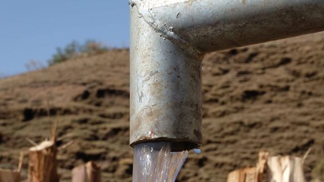 Water flows from a Water For A Village well.