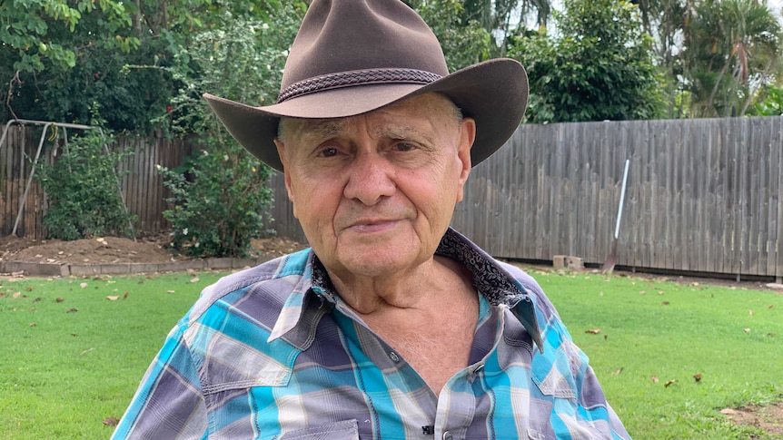 Hans Pearson in the yard of his Townsville home.