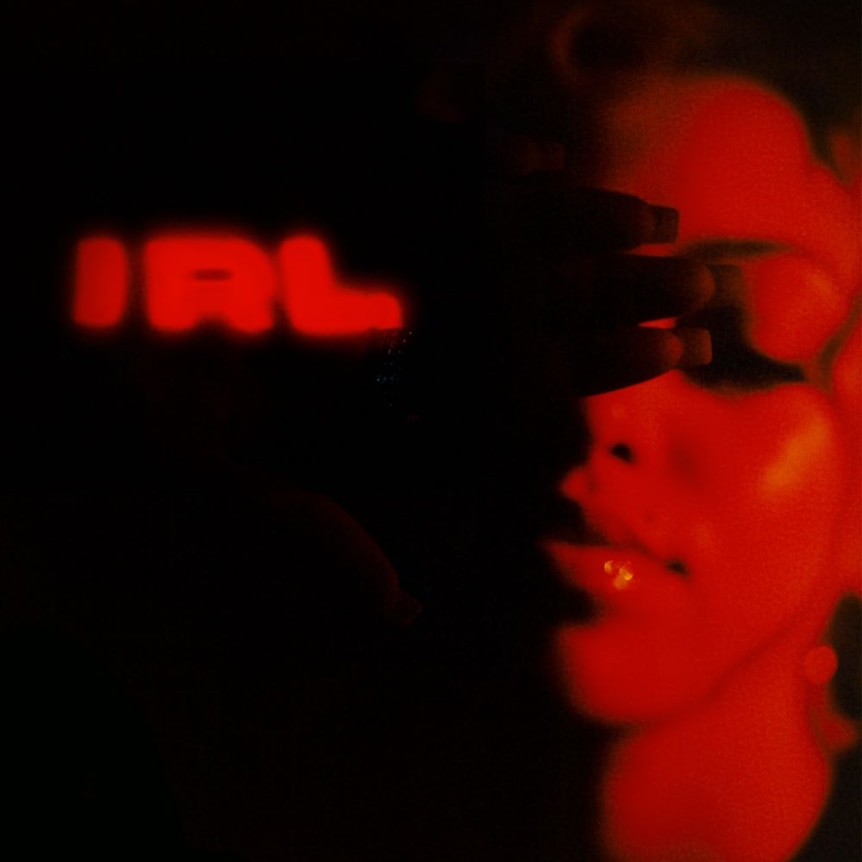 Red and black image of Mahalia with album title 'IRL' on the left.
