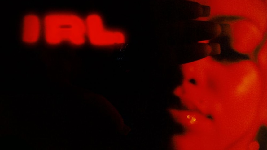 Red and black image of Mahalia with album title 'IRL' on the left.