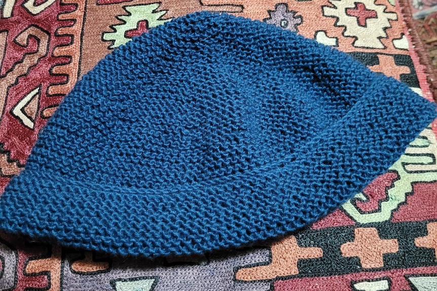 Knitted blue beanie hat