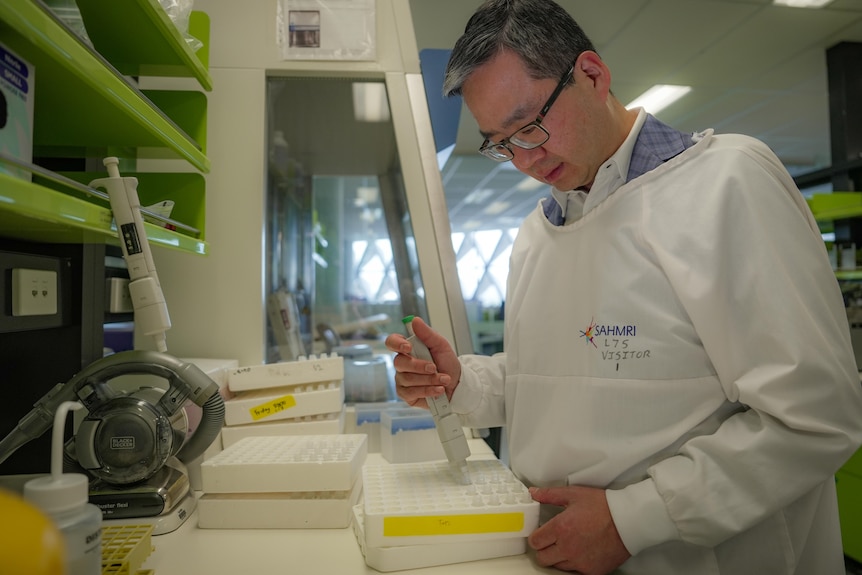 A man uses lab equipment