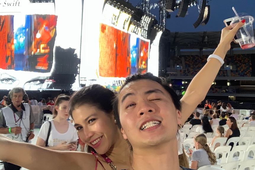 A selfie of a man and a woman at a Taylor Swift concert. 