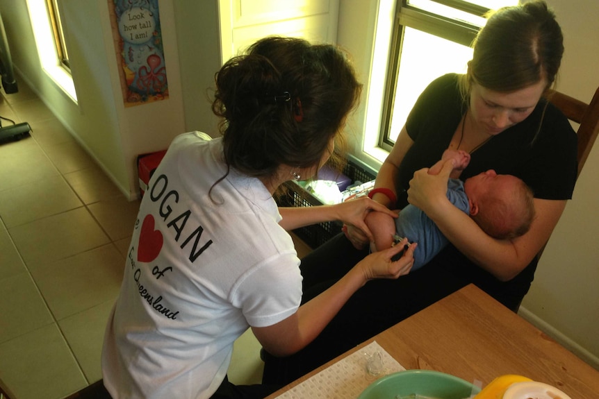 Sandra Javermark gets her daughter vaccinated as part of Logan City's vaccination outreach program.