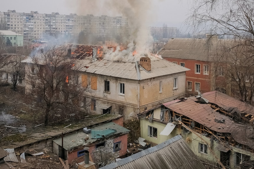 A general view shows shatter windows, damaged buildings and smoke billowing out of the roof.