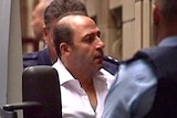 Tony Mokbel escorted from the prison van to the Supreme Court ahead of his sentence on July 3, 2012