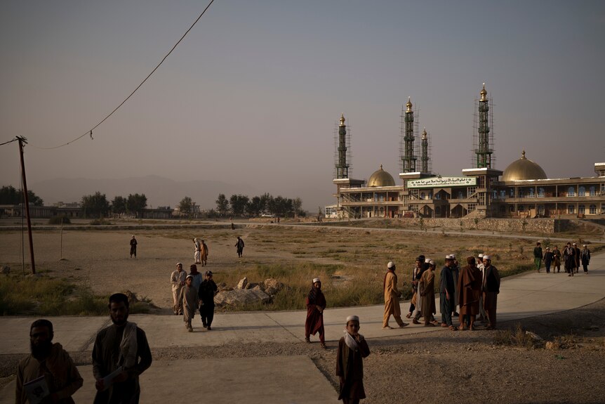 Students walk out of the mosque at the madrassa compound in Kabul on the morning of September 29, 2021.