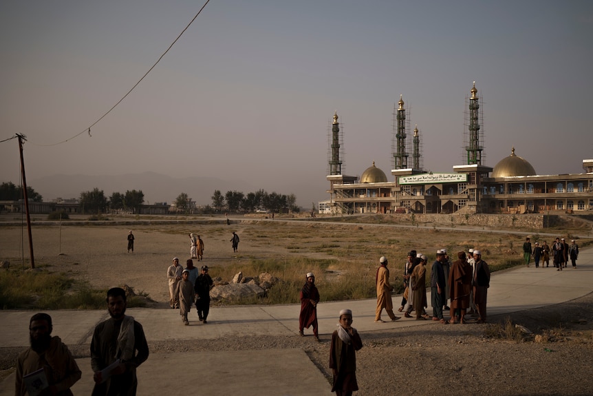 Students walk out of the mosque at the madrassa compound in Kabul on the morning of September 29, 2021.