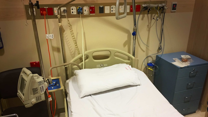 Empty hospital bed in Royal Hobart Hospital Emergency Department.