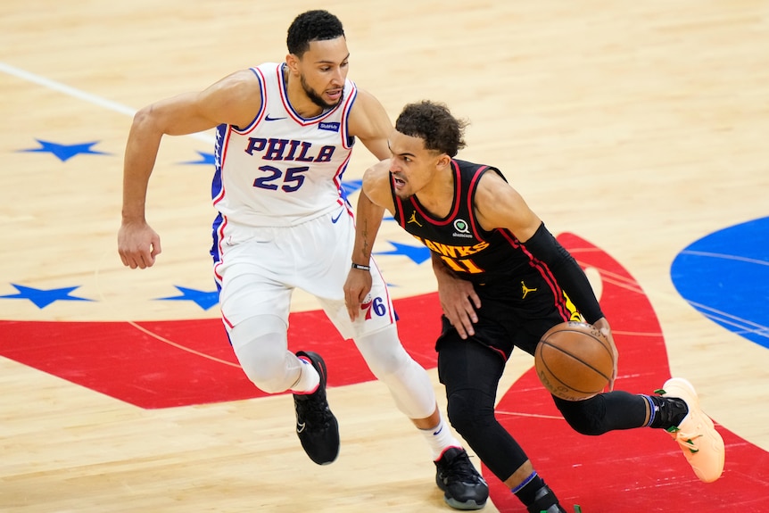 Philadelphia 76ers player Ben Simmons chases Atlanta Hawks guard Trae Young during an NBA playoffs game.