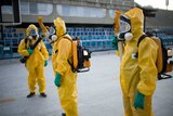 Brazilian workers spray chemicals to kill mosquitoes in Rio de Janeiro