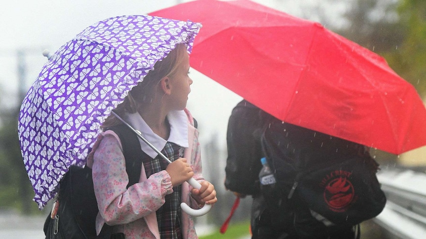 School children on the Gold Coast with umbrellas