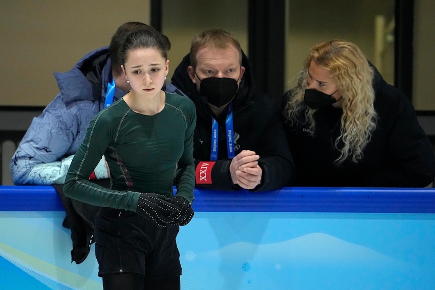 Kamlia Valieva Looks Peturbed As She Talks To Some Adults Over The Rink'S Wall