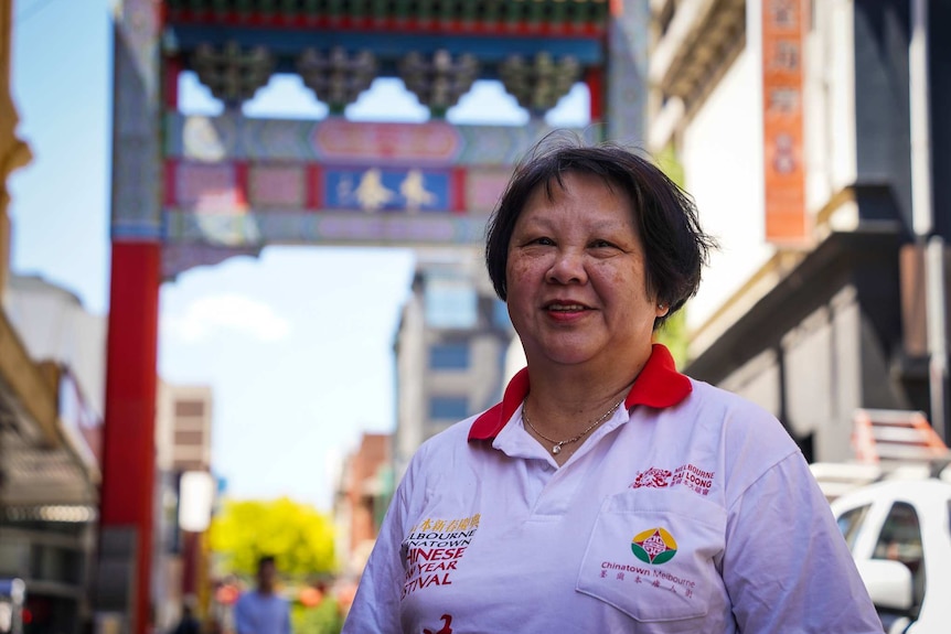 An older woman stands in Melbourne's Chinatown.