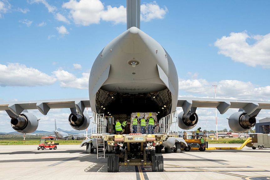 Air Movements Operators load pallets of humanitarian aid bound for Timor Leste.