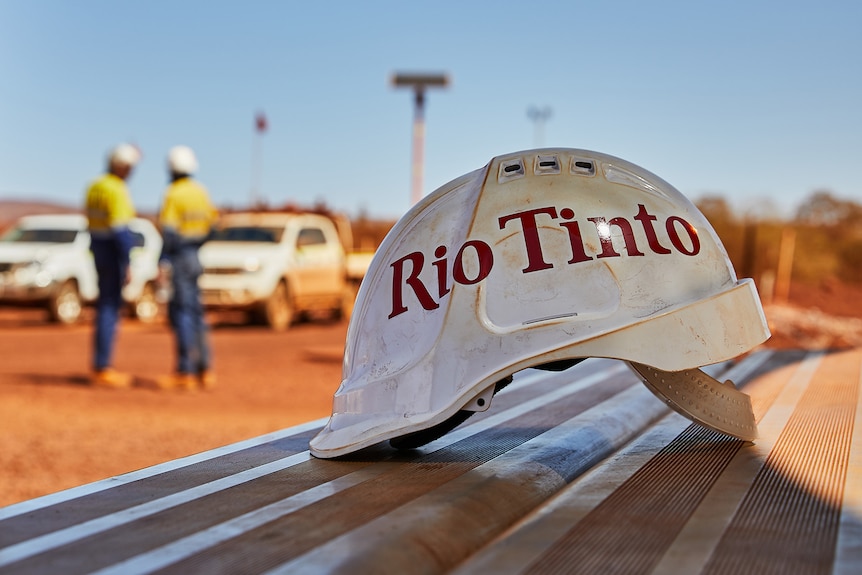 A white miners helmet on a bench with the words Rio Tinto emblazoned in red.