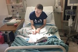 HSC student and Crohn's disease Anna Peterson studying for her exams in her hospital bed.
