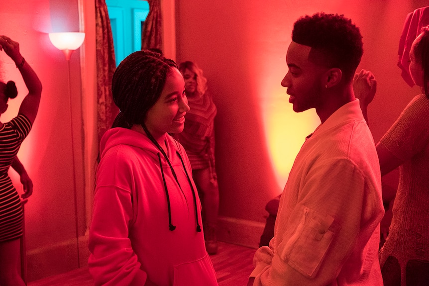 Colour still of Amandla Stenberg and Algee Smith at a party in 2018 film The Hate U Give.