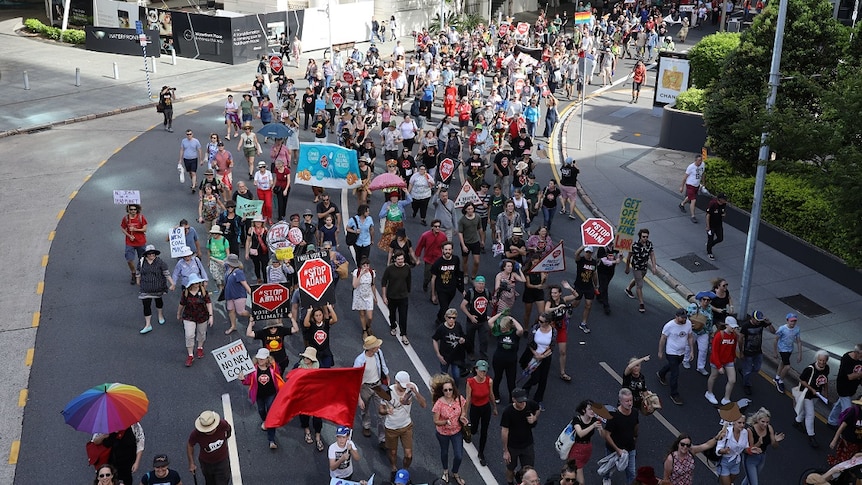 Hundreds of anti-Adani protestors march through Brisbane city.