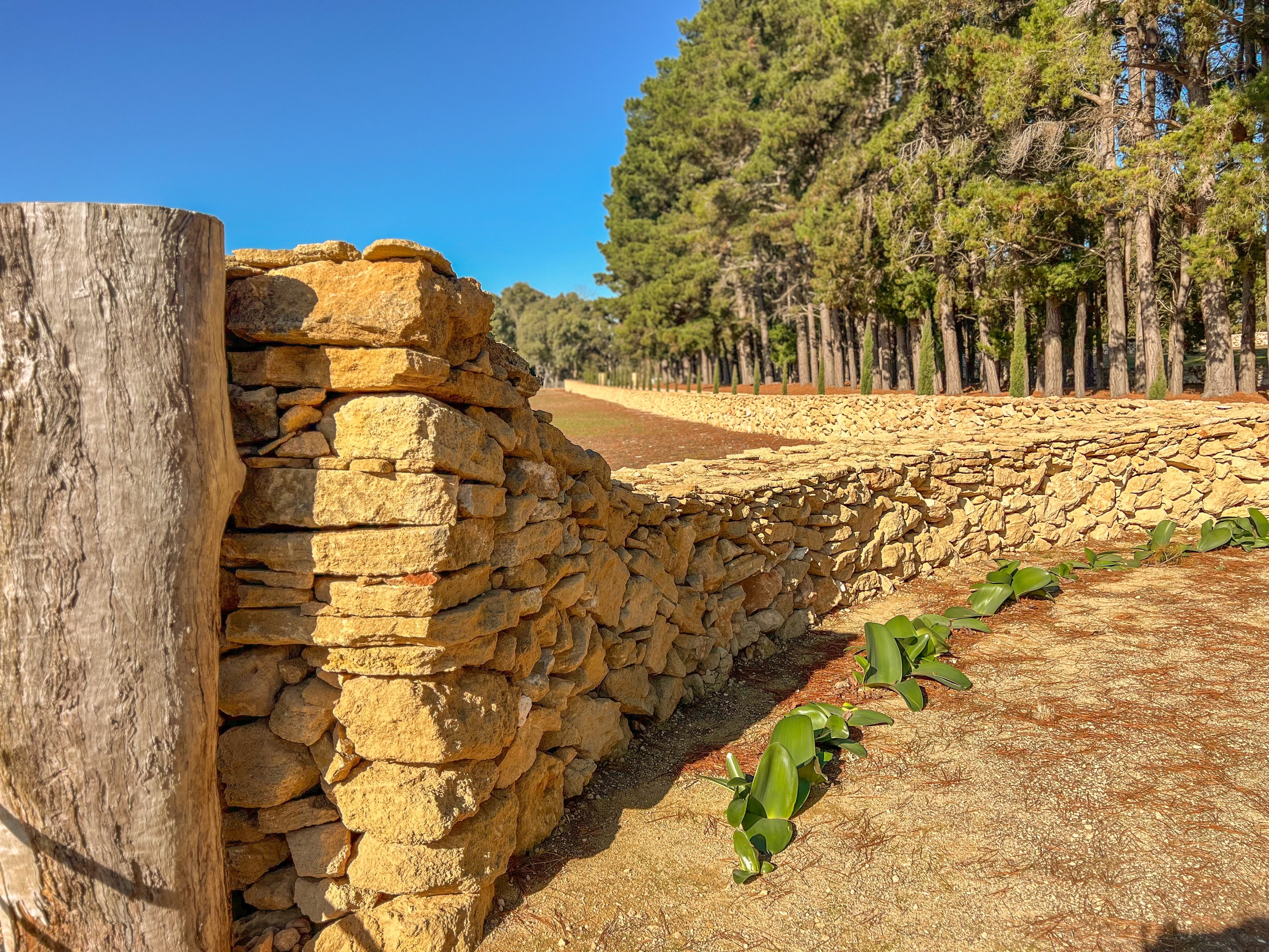 a sandstone drystone wall approx 1m tall and 80cm wide