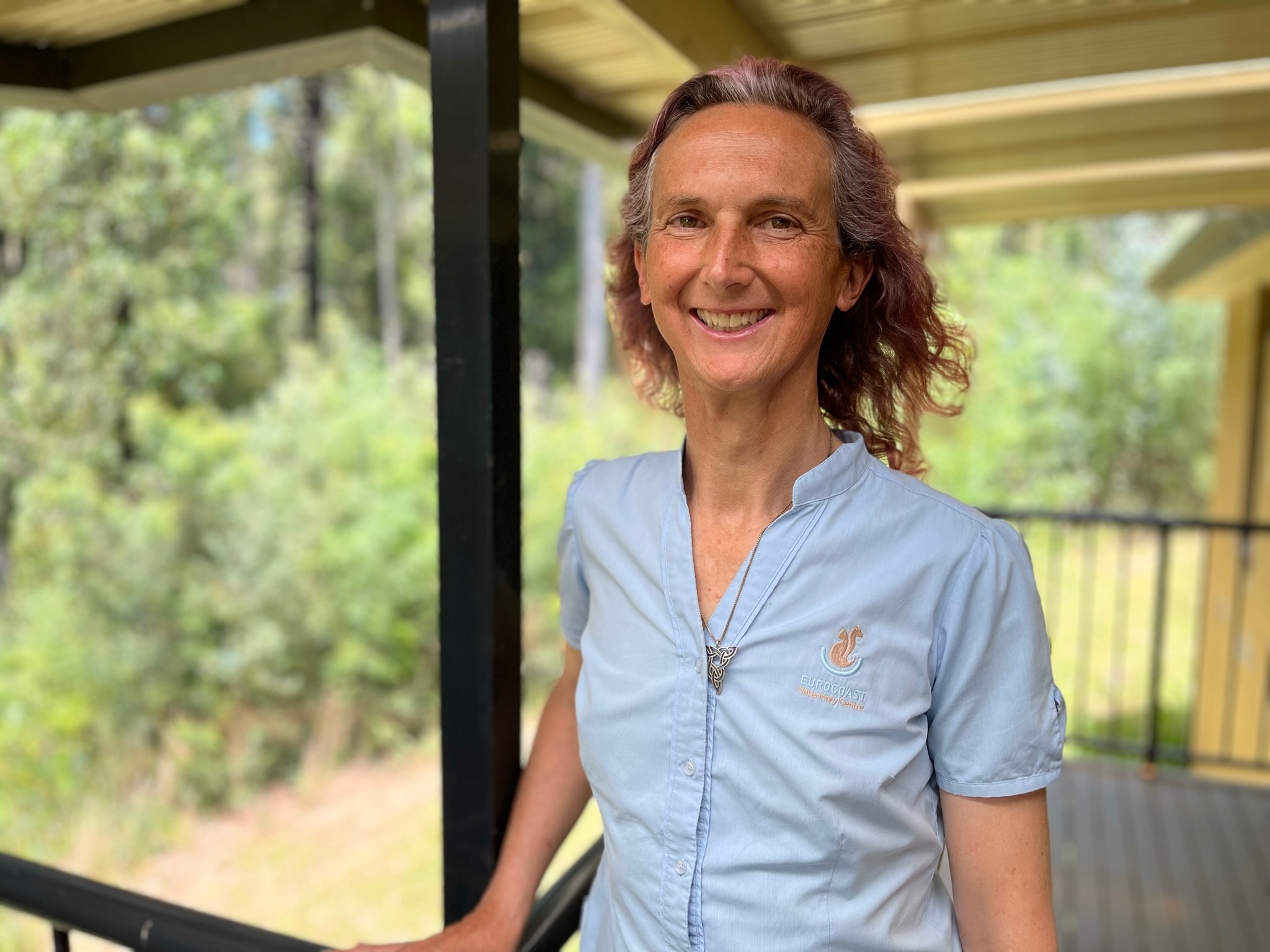 a woman standing on a verandah