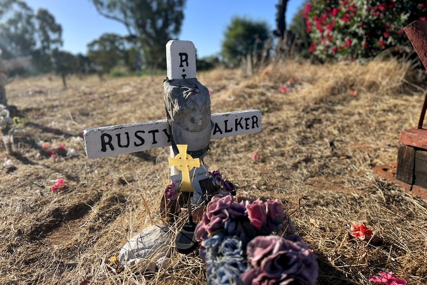 A white cross reads 'Rusty Walker' with a gap and cross attached.