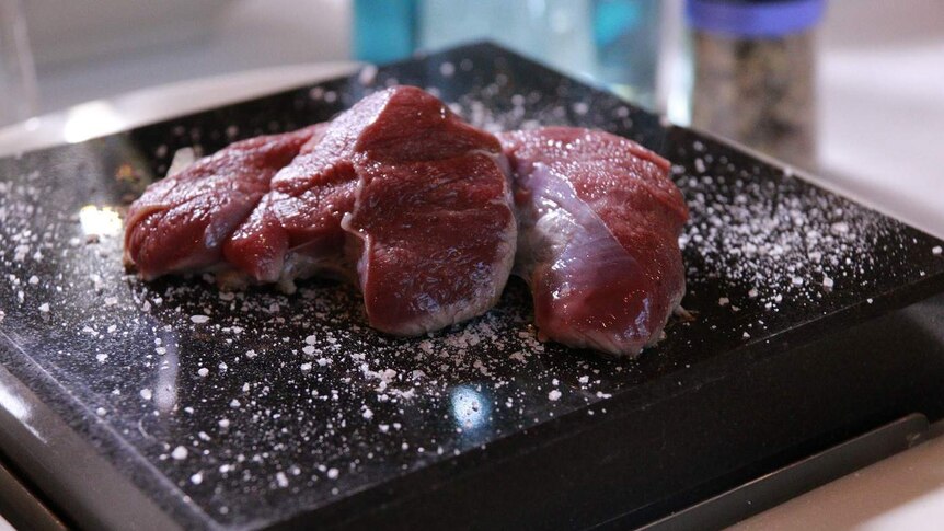 Raw meat on a hot salted stone.