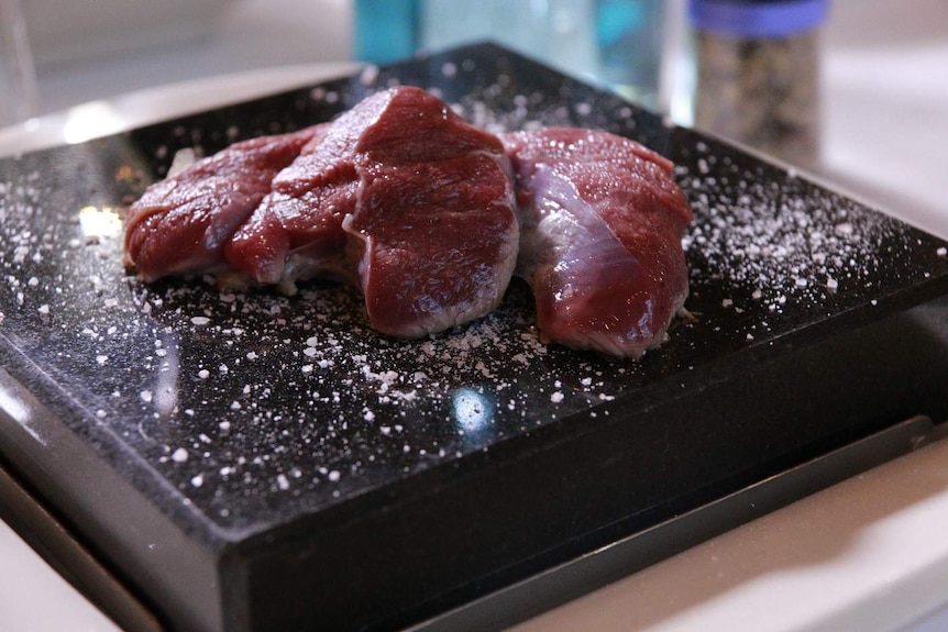 Raw meat on a hot salted stone.