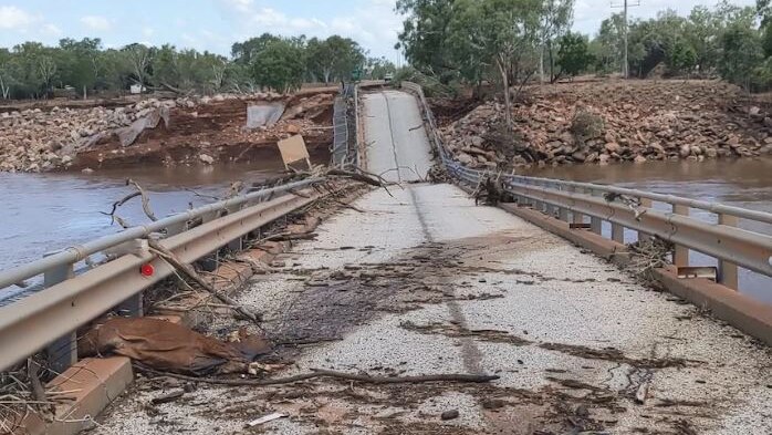 A photo of a collapsed bridge with debris over it.