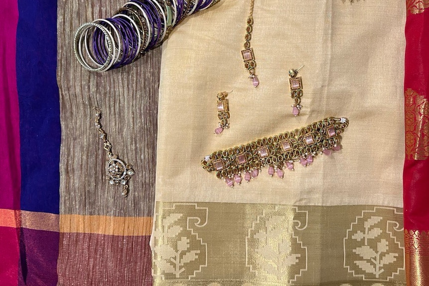 Flat lay of Saree fabrics with accessories laid out on them