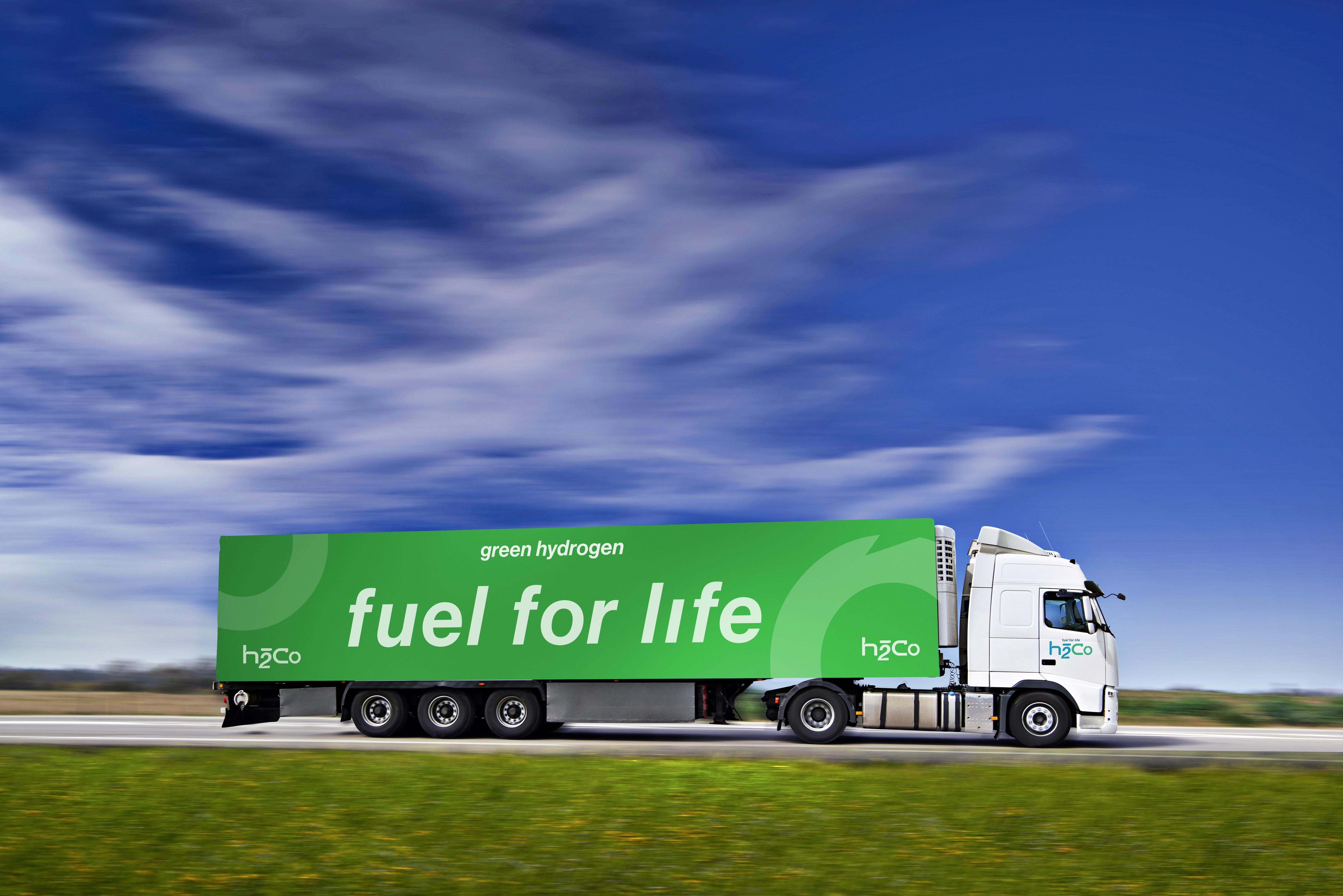 A computer generated image of a white truck towing a green trailer that reads 'Fuel for life'