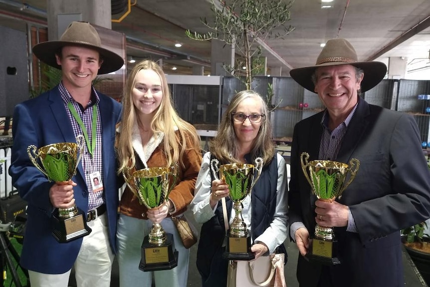 The Arnett family with trophies