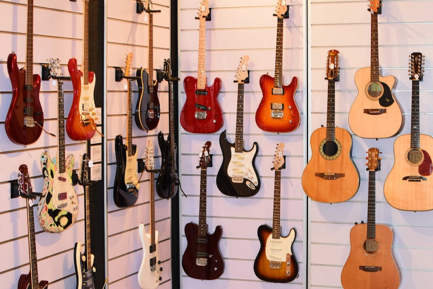 Guitars on display against a wall