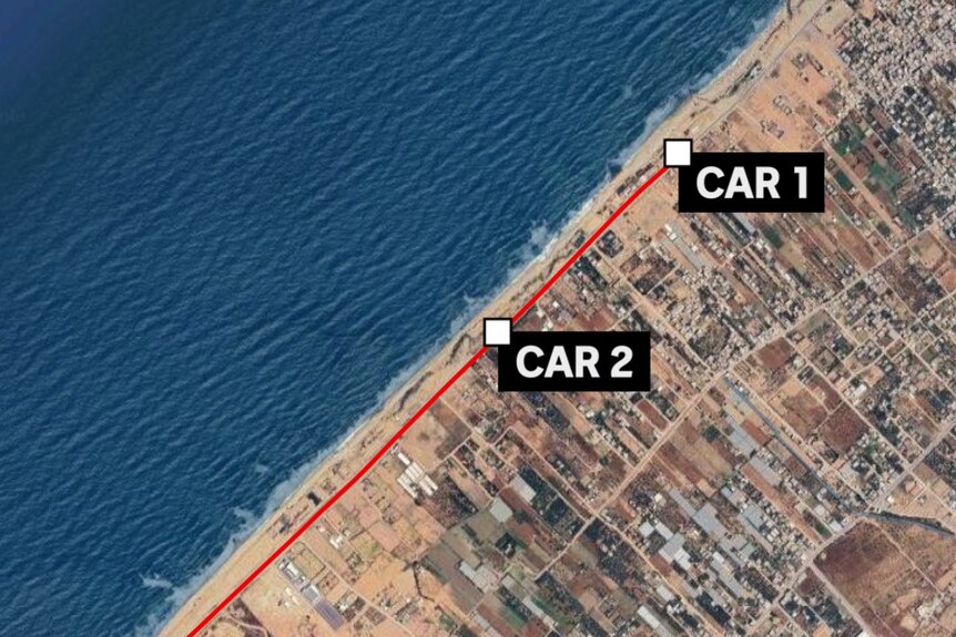 Satellite image of three cars on coastal road. 