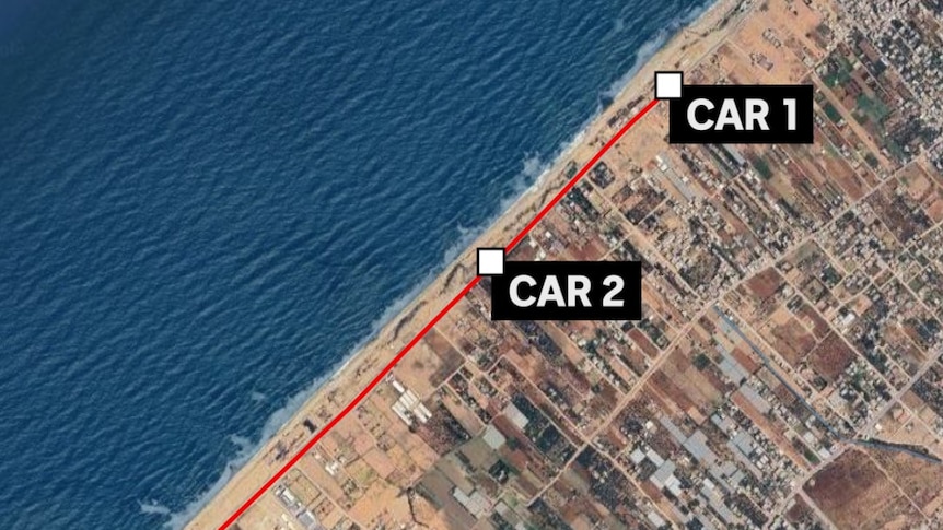 Satellite image of three cars on coastal road. 